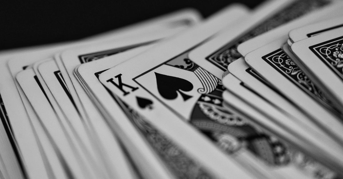 Black and white close-up of a deck of playing cards featuring the King of Spades.
